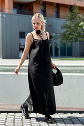 a lady in a black slip dress made of xiangyun silk